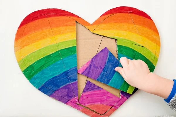 Heart shape rainbow puzzle. Table game. Brain exercises at home. Montessori, fine motoric skills, early education.
