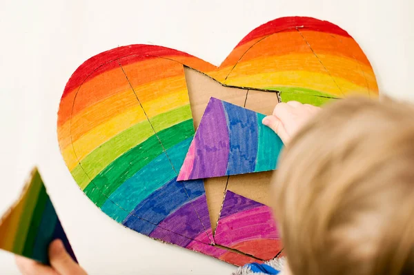 Heart shape rainbow puzzle. Table game. Brain exercises at home. Montessori, fine motoric skills, early education.