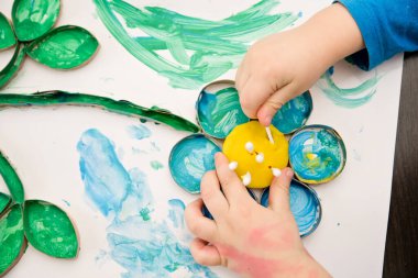 Erken dönem BlueBell çiçekleri. Gouache ile resim yapan çocuk. Evdeki DIY oyunları. Çocuk sanatında filizlenen kır çiçekleri. Anneler Günü teması.