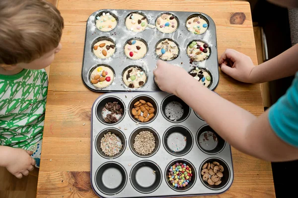 Boy Decorating Cupcake Taking Sprinkles Nuts Decorations Baking Form Baking Royalty Free Stock Images