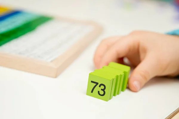 Mats educational game. To develop fine motoric skills, the sequence of numbers. primary school pupils and aspiring maths pros. Colorful wood cubes with numbers from1 to 100. Digits, basic mathematic