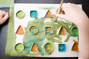 Çocuk geometrik şekilleri öğreniyor. Güzel motor beceriler. Anaokulu ya da özel görevler. Çocukların erken eğitimi. Montessori yöntembilimi.