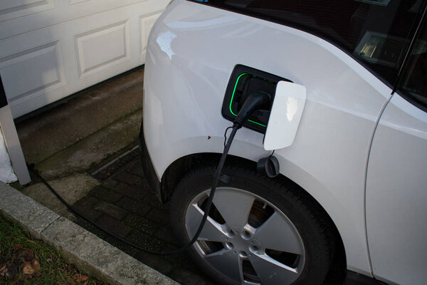Electric Car Charger At Home - Charging EV with lights on