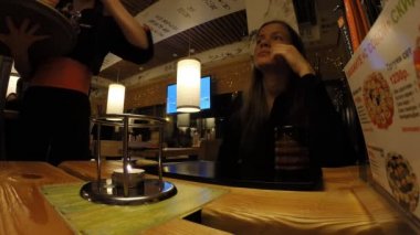 Kız bir Japon restoran Tanuki çay içecekler