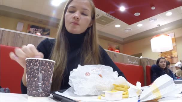 A menina come no restaurante Burger King — Vídeo de Stock