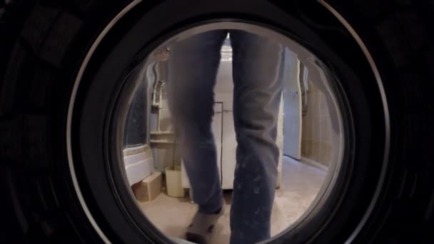 Washing machine inside. Man laying on linen washing — Stock Video