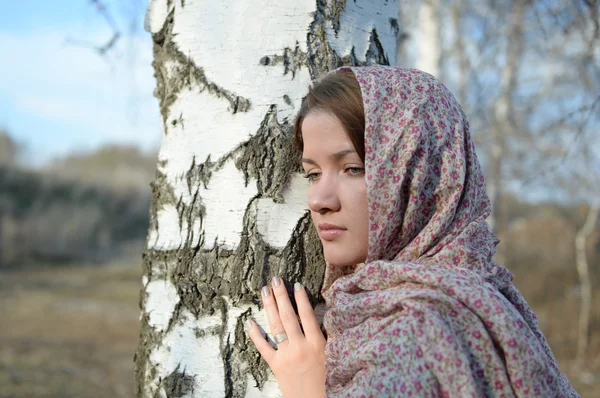 Fille russe dans une écharpe dans une forêt de bouleaux gros plan — Photo