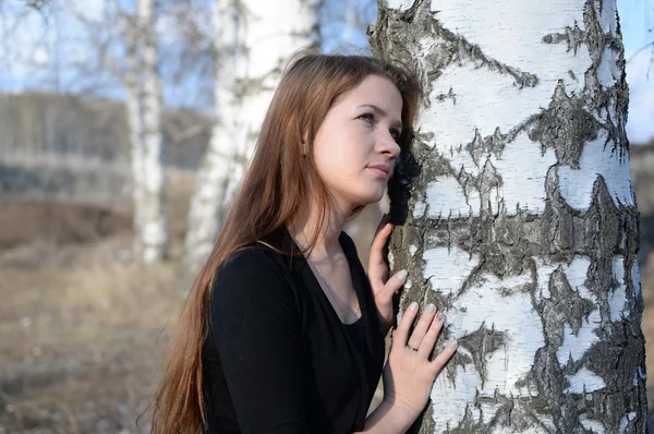 Ragazza dai capelli lunghi in una foresta di betulle russa, primo piano — Foto Stock