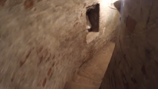 The descent down the narrow dark hallway stairs ancient cave — Stock Video