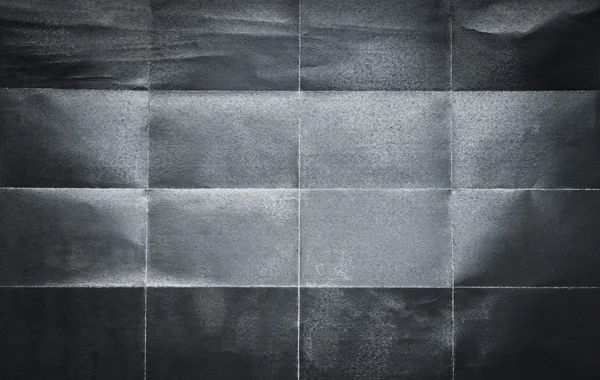 16 の部分に折り畳まれた黒い紙の背景パターン — ストック写真