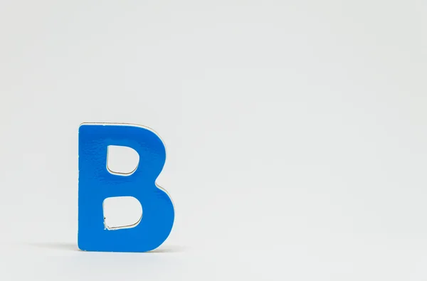 Blue wooden alphabet B with white background and selective focus — Stock Photo, Image