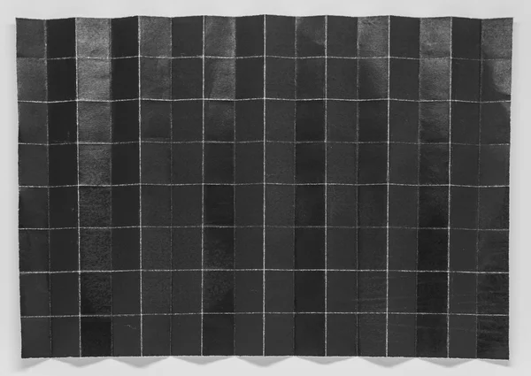 Papel negro plegado en 128 partes con fondo blanco —  Fotos de Stock