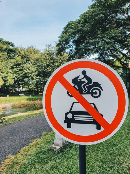 Red circle traffic sign warning passenger car and motorcycle cannot pass the way through the garden