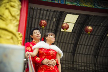 Qipao takım elbise ile güzel çift Çince tapınakta sarılmak