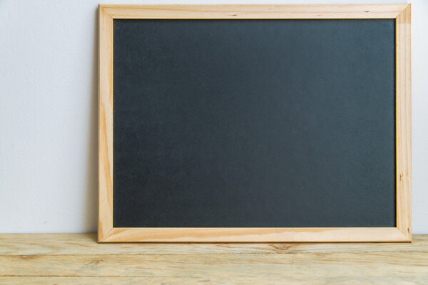 Blank black board on the wall 1