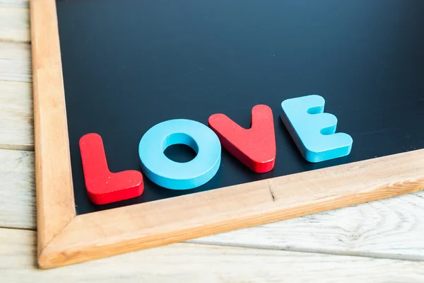 Palabra de madera LOVE on Black board 1 —  Fotos de Stock