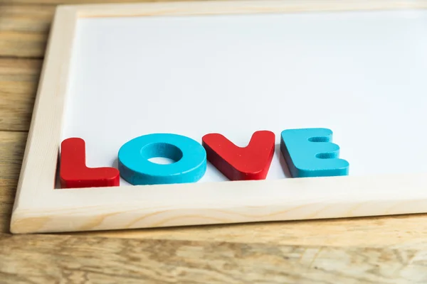 Palabra de madera LOVE on White board 3 —  Fotos de Stock