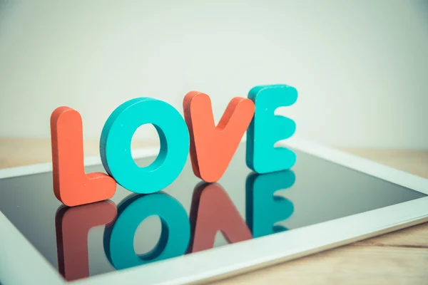 Wooden word LOVE stand on tablet in vintage style 6 — Stock Photo, Image