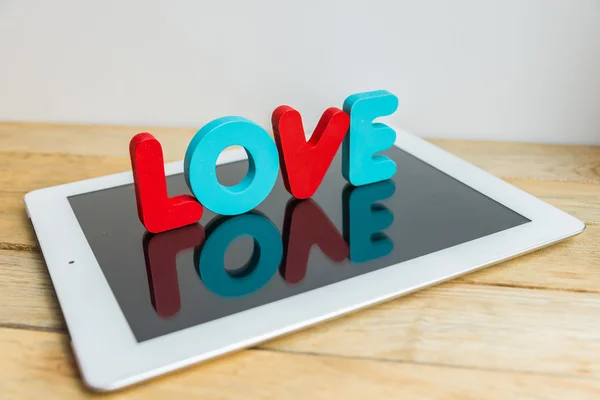 Wooden word LOVE stand on tablet 6 — Stock Photo, Image