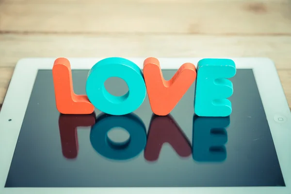 Wooden word LOVE stand on tablet in vintage style 2 — Stock Photo, Image