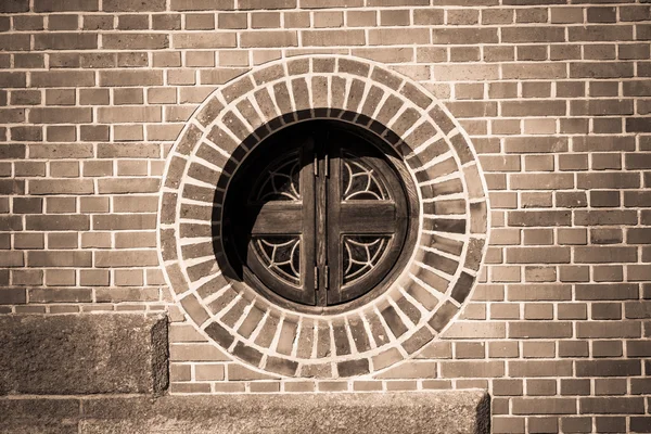 Circle window on the brick wall in monochrome style
