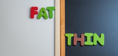 Wooden word FAT and THIN on black board and white board clipart