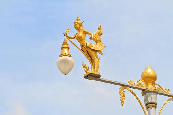 Half-bird half-woman on street lamp — Stock Photo, Image