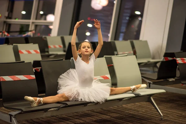 Girl ballerina at the airport. Airport and masked ballerina