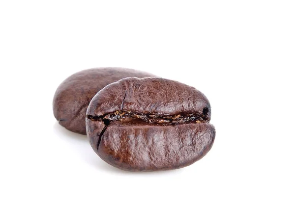 Kızarmış kahve çekirdekleri beyaz arka planda izole edilmiş.