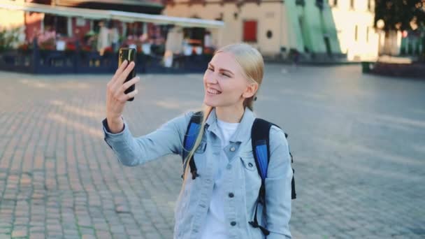 Женщина-туристка делает видеозвонок на смартфон с места своего визита — стоковое видео