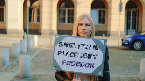 Woman protesting that shelter in place does not mean freedom