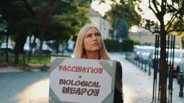 Young woman protesting against vaccination like biological weapon
