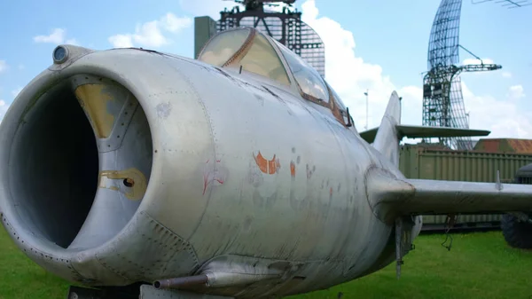 Old jet fighter aircraft in open-air military museum.