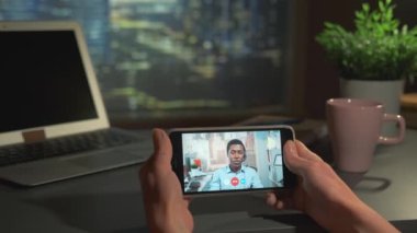 Ofisten müdürle video görüşmesi yapan akıllı telefon.
