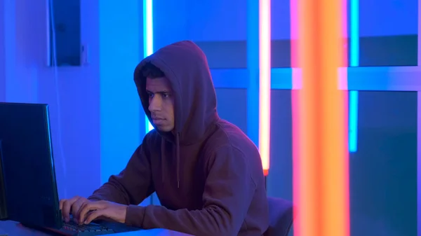 African hacker dressed in hoodie working on the computer — Stok fotoğraf