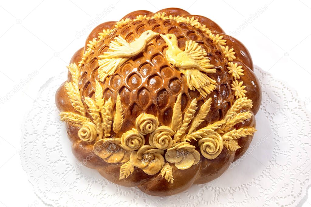 Traditional Russian wedding round loaf isolated on white background top view.