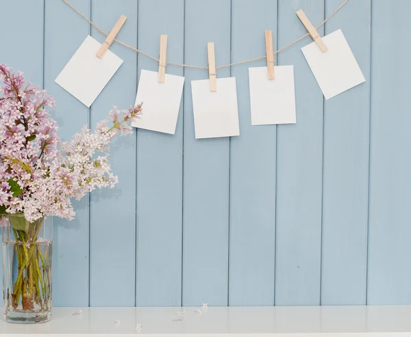 Photographs on the clothespin and bunch of lilac — Stock Photo, Image