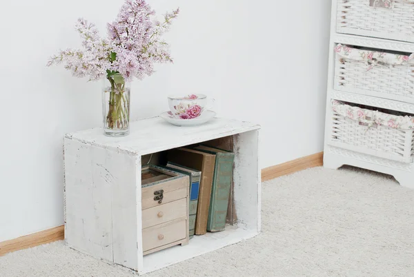 Lilac and tea on vintage nightstand — Stock Photo, Image