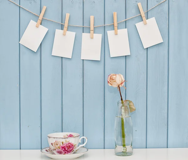 Photos hanging on rope with clothespins — Stock Photo, Image