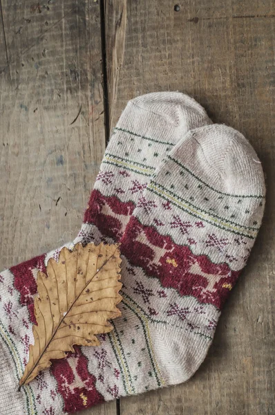 Вязаные шерстяные носки и дубовый лист — стоковое фото