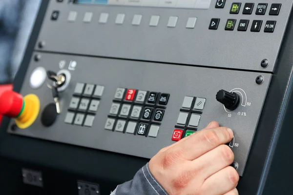 Operating the controls of CNC machine — Stock Photo, Image