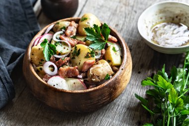 Patates, domuz pastırması ve ahşap kasede turp salatası.