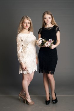 two blonds in goffering dress with bouquets of flowers