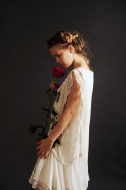 girl with a red rose, girl in a nightgown, girl in white on a black background
