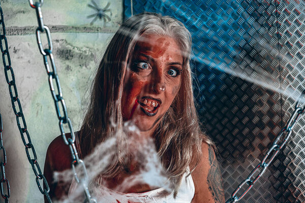 Halloween photo session in the studio. Bloody woman. Cool