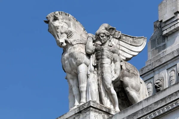 Statue of a man holding a winged horse on the Milan's main railw — Stock Photo, Image