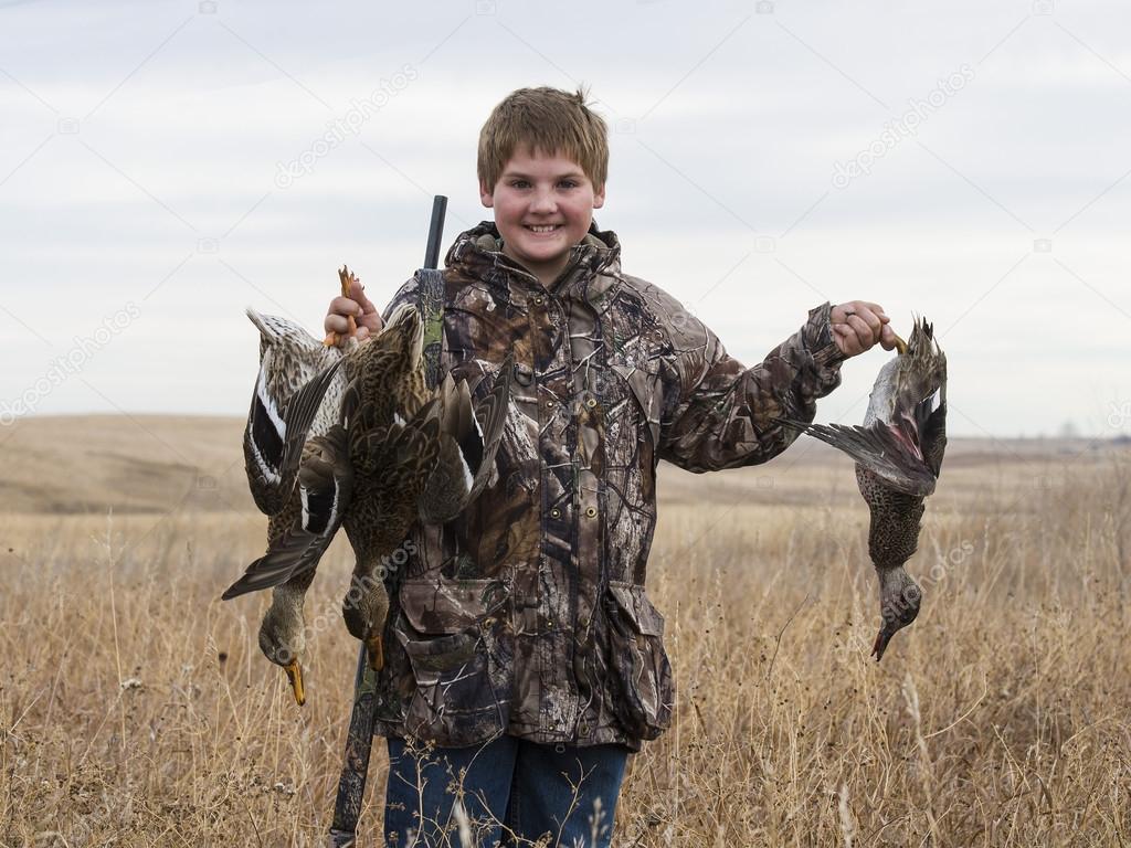 A young Duck Hunter with ducks in North Dakota