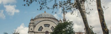 Low angle view of islamic Mosque of Mihrimah Sultan in Istanbul, Turkey, banner  clipart