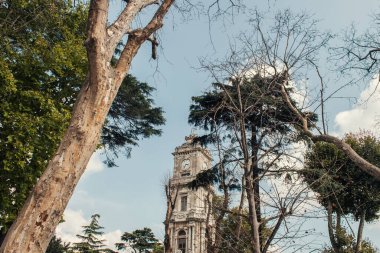 Clock tower of Dolmabahce palace on street in Istanbul, Turkey  clipart