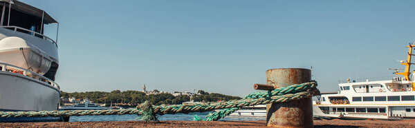 Rope of moored ship on coast in Istanbul, Turkey, banner 